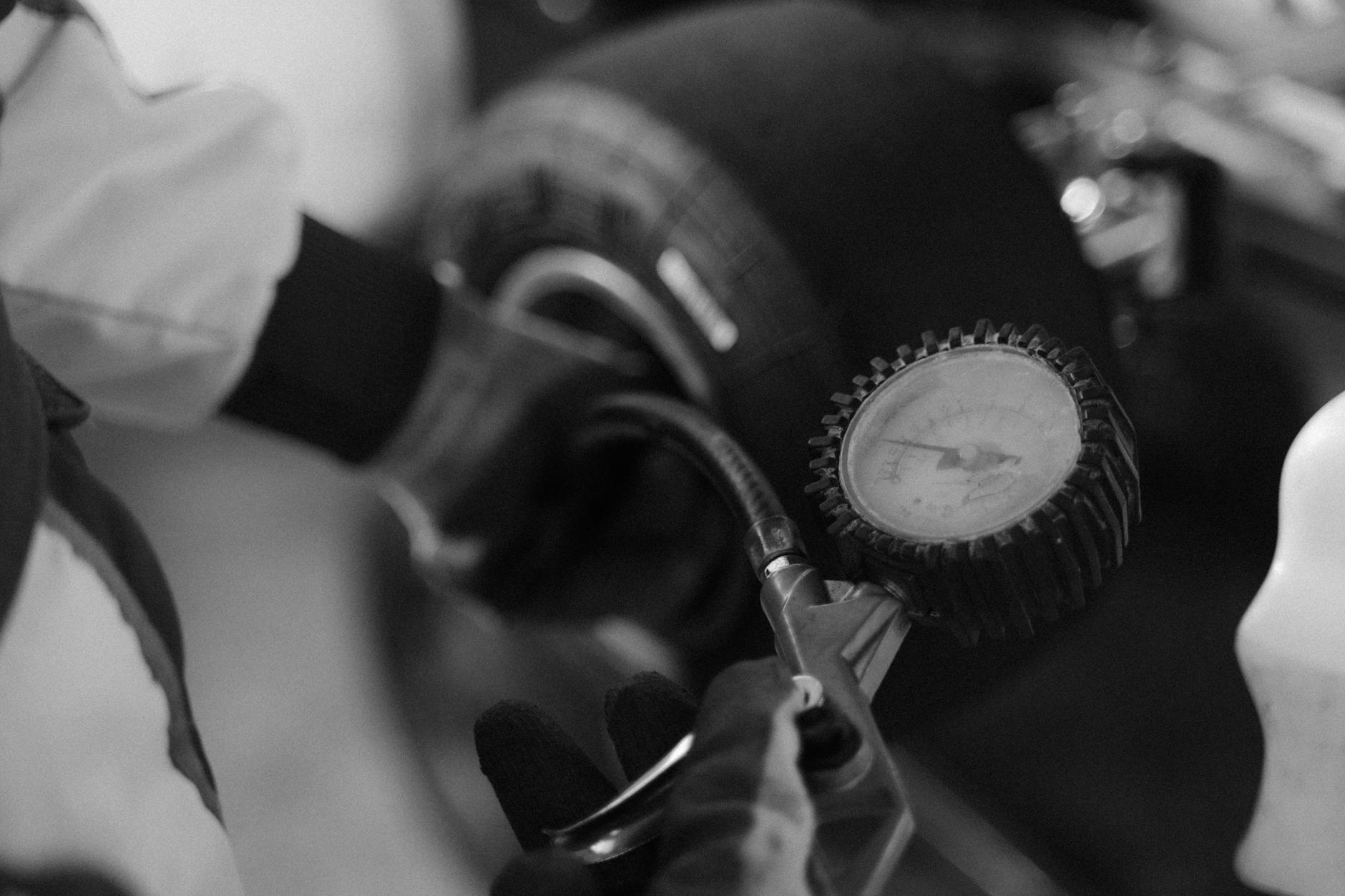 checking kart tire pressure in black and white